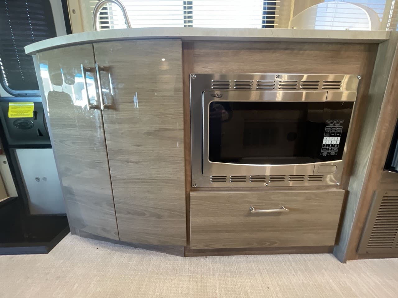Entegra Coach QWEST 24 galley with solid-surface counters, convection microwave, and refrigerator
