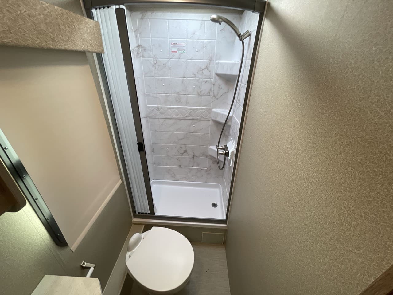 Entegra Coach QWEST 24 tiled shower with skylight